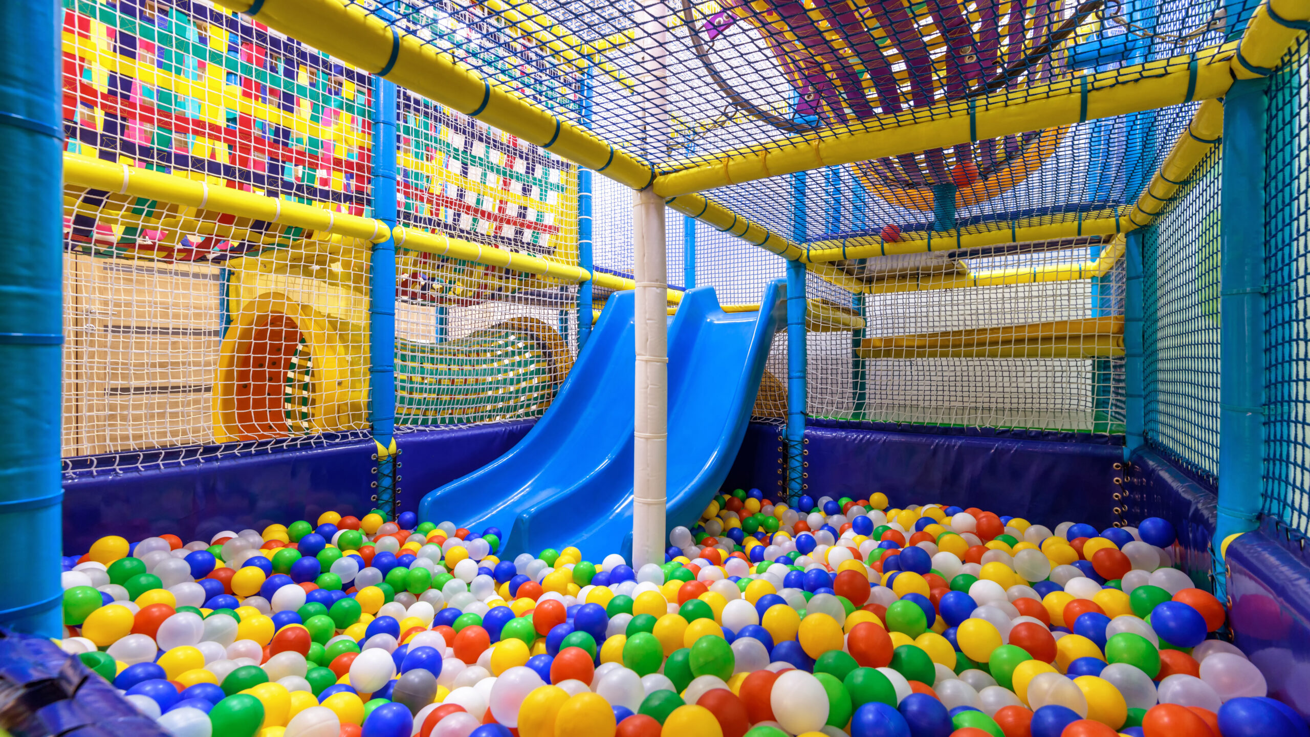 soft play area with blue slides and colourful balls