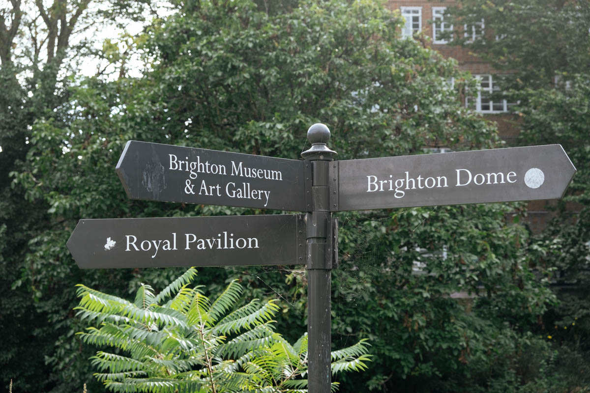 signpost in the pavilion gardens in Brighton showing directions to Brighton museum, dome and pavilion